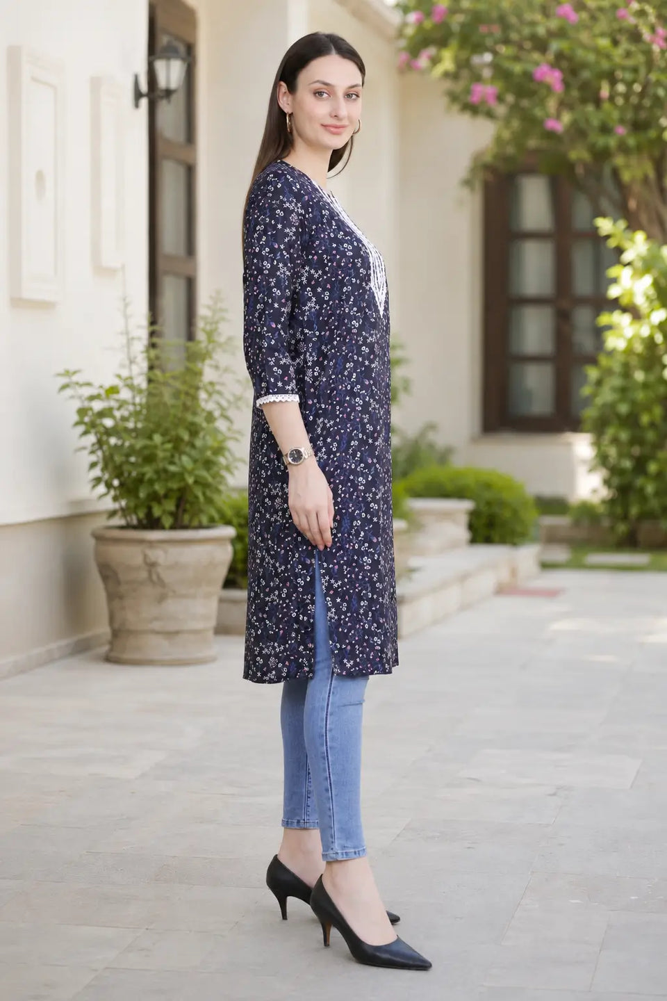 Side view of Rabric navy blue cotton floral printed long kurti for women with V-neck embroidery, 3/4 sleeves and side slit design.
