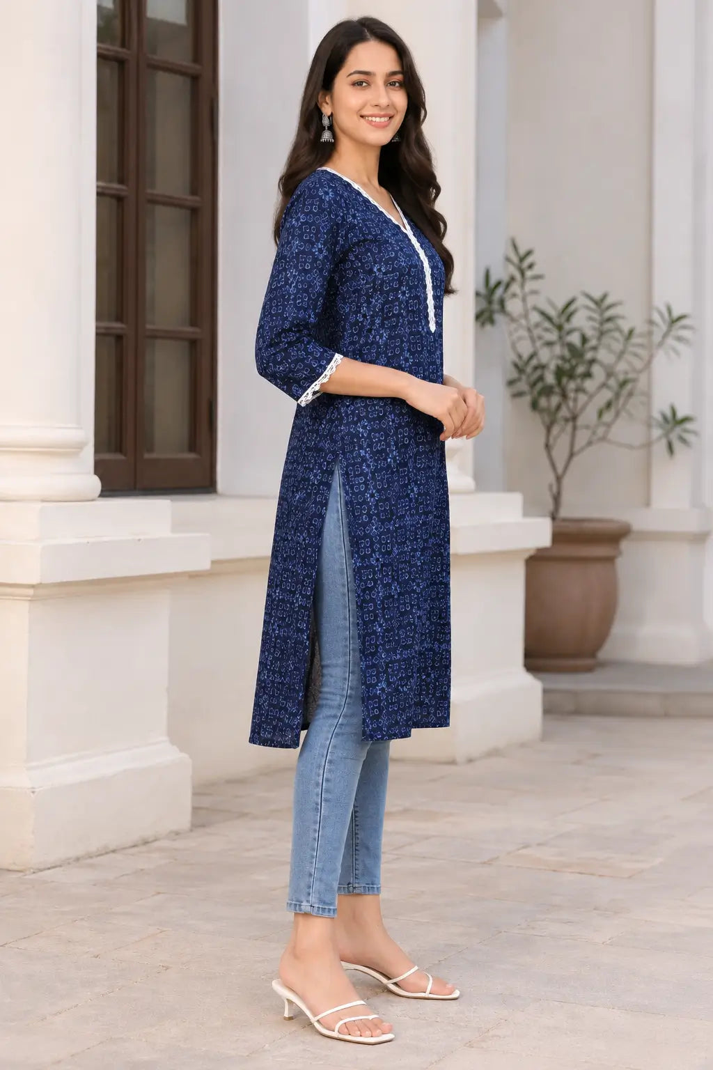 Side view of Rabric navy blue cotton long kurti with light blue geometric floral print, V neck, white lace detailing and side slit