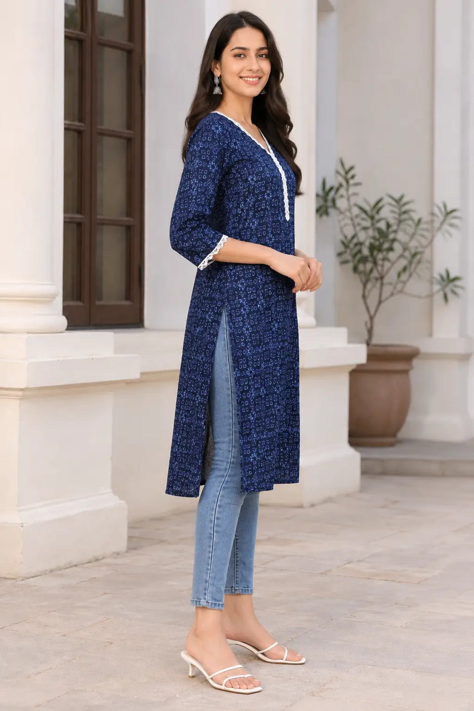 Side view of Rabric navy blue cotton long kurti with light blue geometric floral print, V neck, white lace detailing and side slit