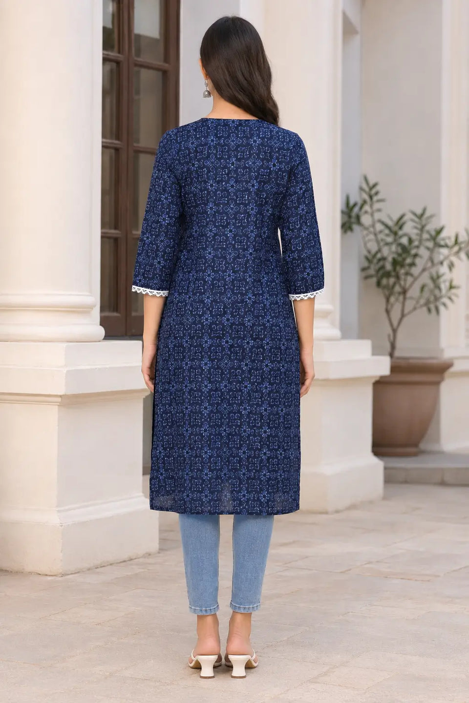 Back view of Rabric navy blue cotton printed long kurti for women with all-over light blue geometric floral motif print and 3/4 sleeves