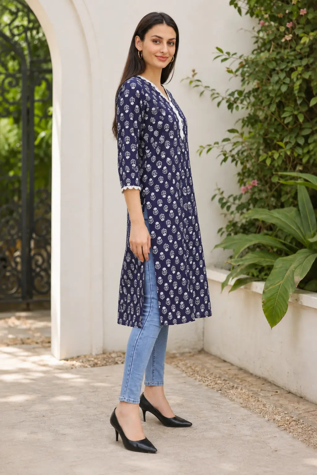 Rabric navy blue cotton straight fit kurti with white leaf floral print, embroidered V-neck and side slit – side view for women