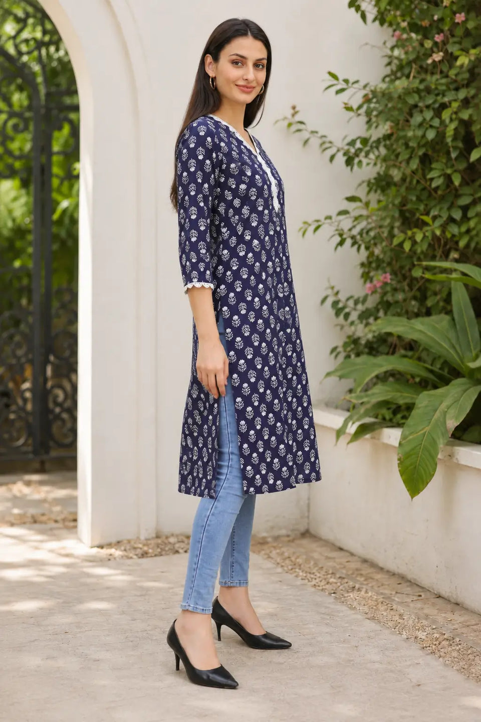 Rabric navy blue cotton straight fit kurti with white leaf floral print, embroidered V-neck and side slit – side view for women