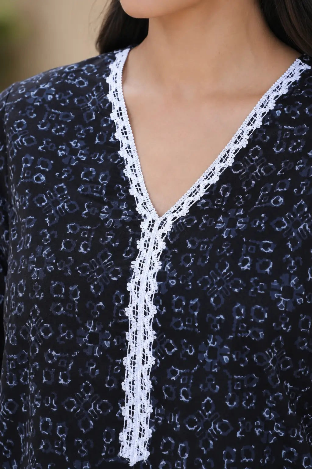 Rabric navy blue cotton V neck kurti with abstract geometric print and detailed white embroidered lace neckline for women