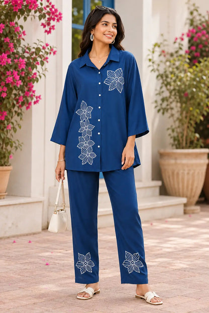 Rabric navy blue rayon co-ord set for women with white floral embroidery, shirt collar, 3/4 sleeves and matching pant front view
