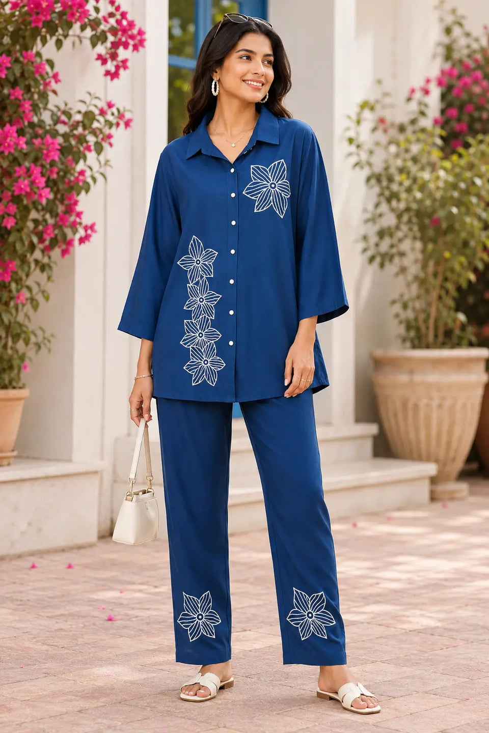 Rabric navy blue rayon co-ord set for women with white floral embroidery, shirt collar, 3/4 sleeves and matching pant front view