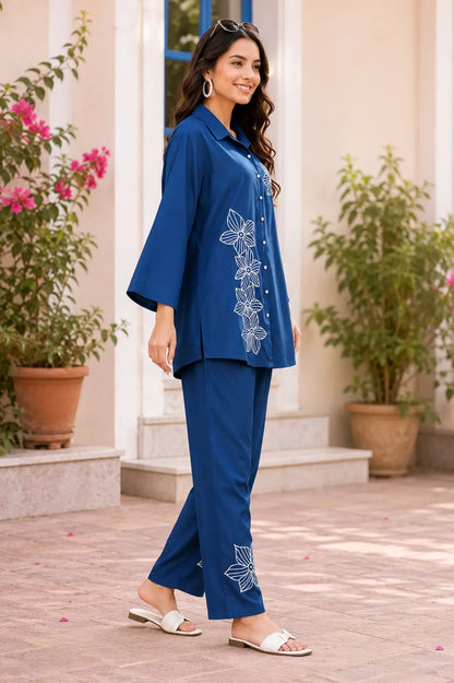 Side angle of Rabric navy blue rayon floral embroidered co-ord set for women with stylish shirt and matching pant
