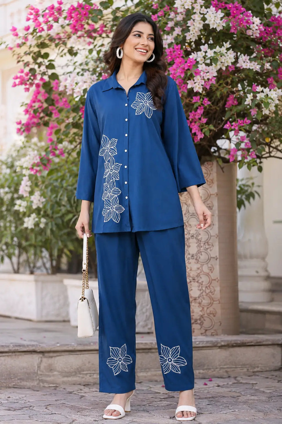 Lifestyle image of Rabric navy blue rayon floral embroidered co-ord set for women styled with casual accessories