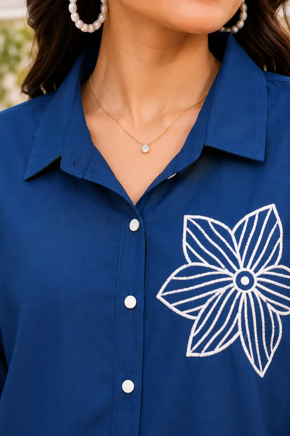 Close up of Rabric navy blue rayon co-ord shirt collar neck design with white buttons and floral embroidery detail