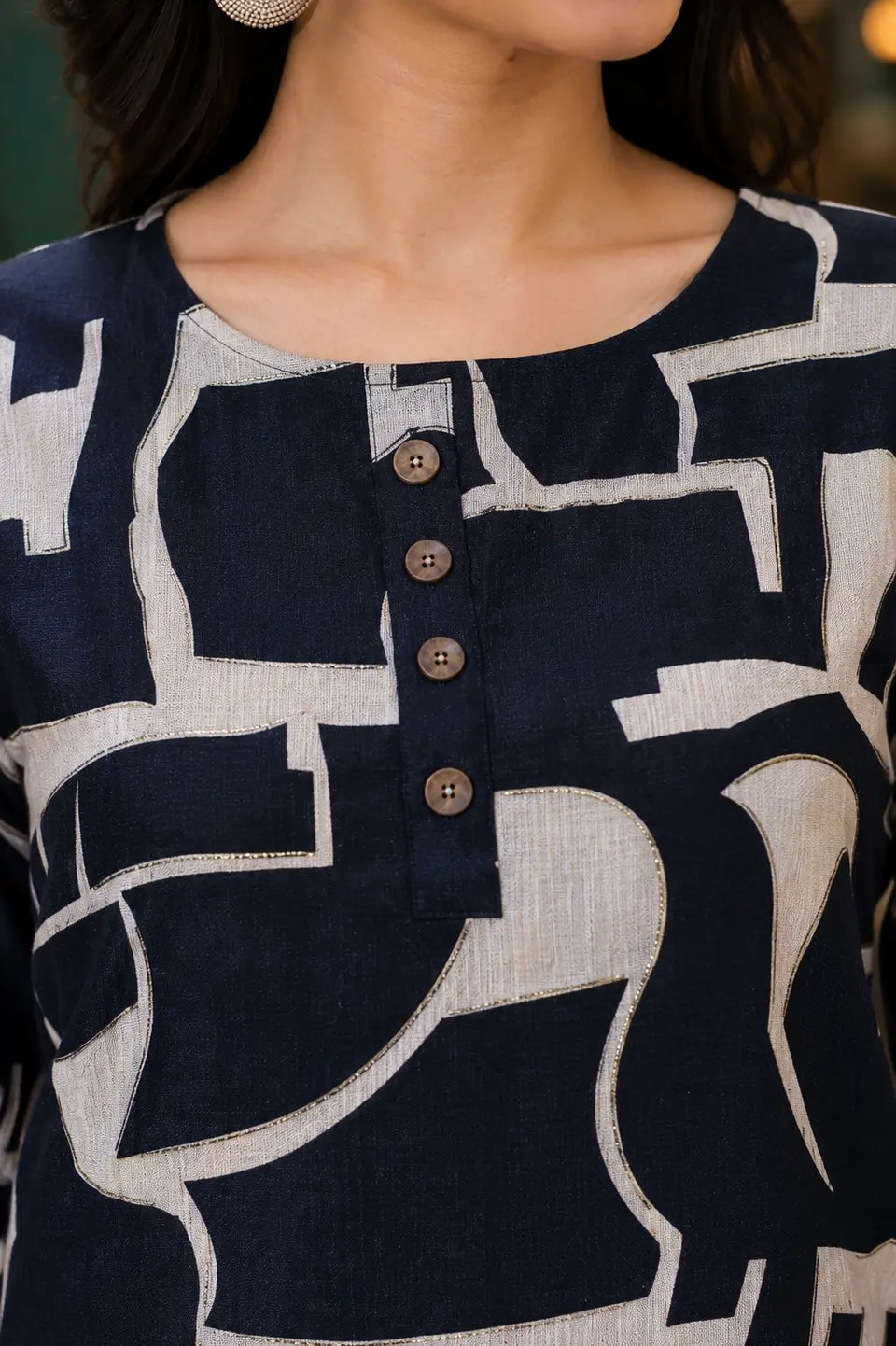Close-up of Rabric navy blue Vertican Silk top with round button neck design, beige abstract geometric print and 3/4 sleeves