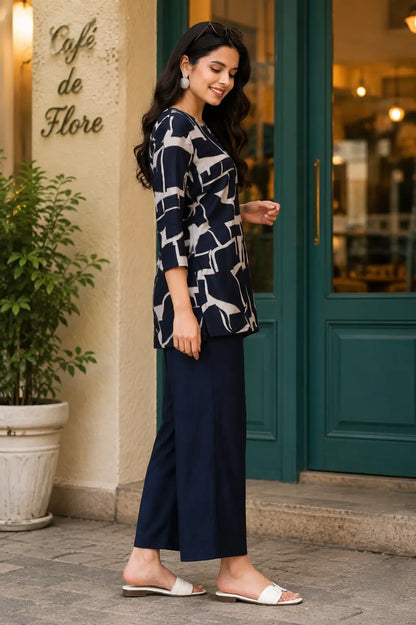 Side angle of Rabric navy blue Vertican Silk co-ord set with beige abstract geometric printed short kurti and matching pants
