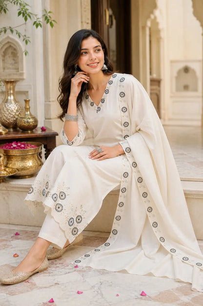 Elegant sitting pose featuring Rabric off white cambric cotton ethnic kurta pant set with embroidered dupatta for women