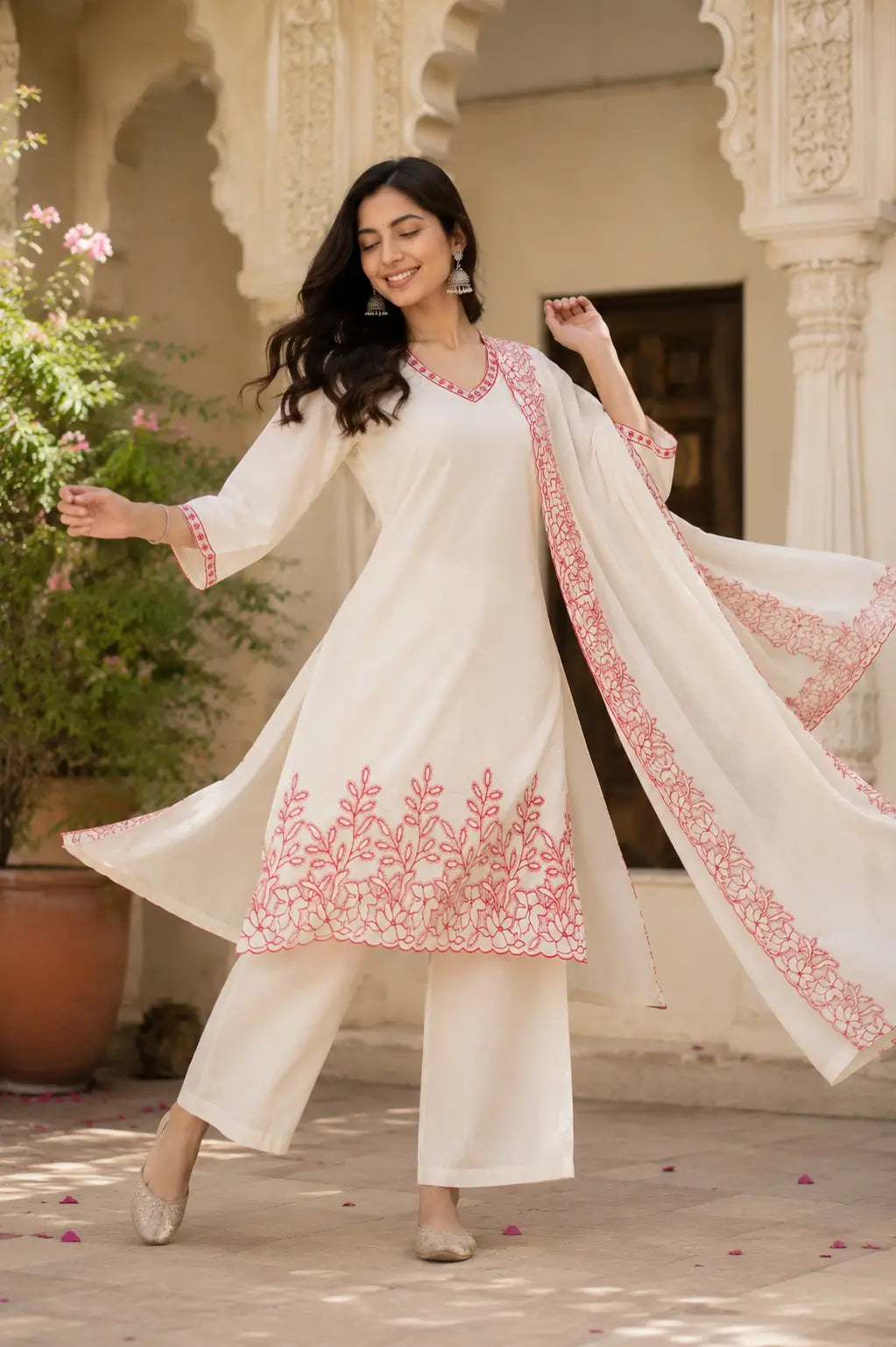 Dancing pose showing flare of Rabric off white cambric cotton kurta pant set with embroidered dupatta for festive ethnic wear
