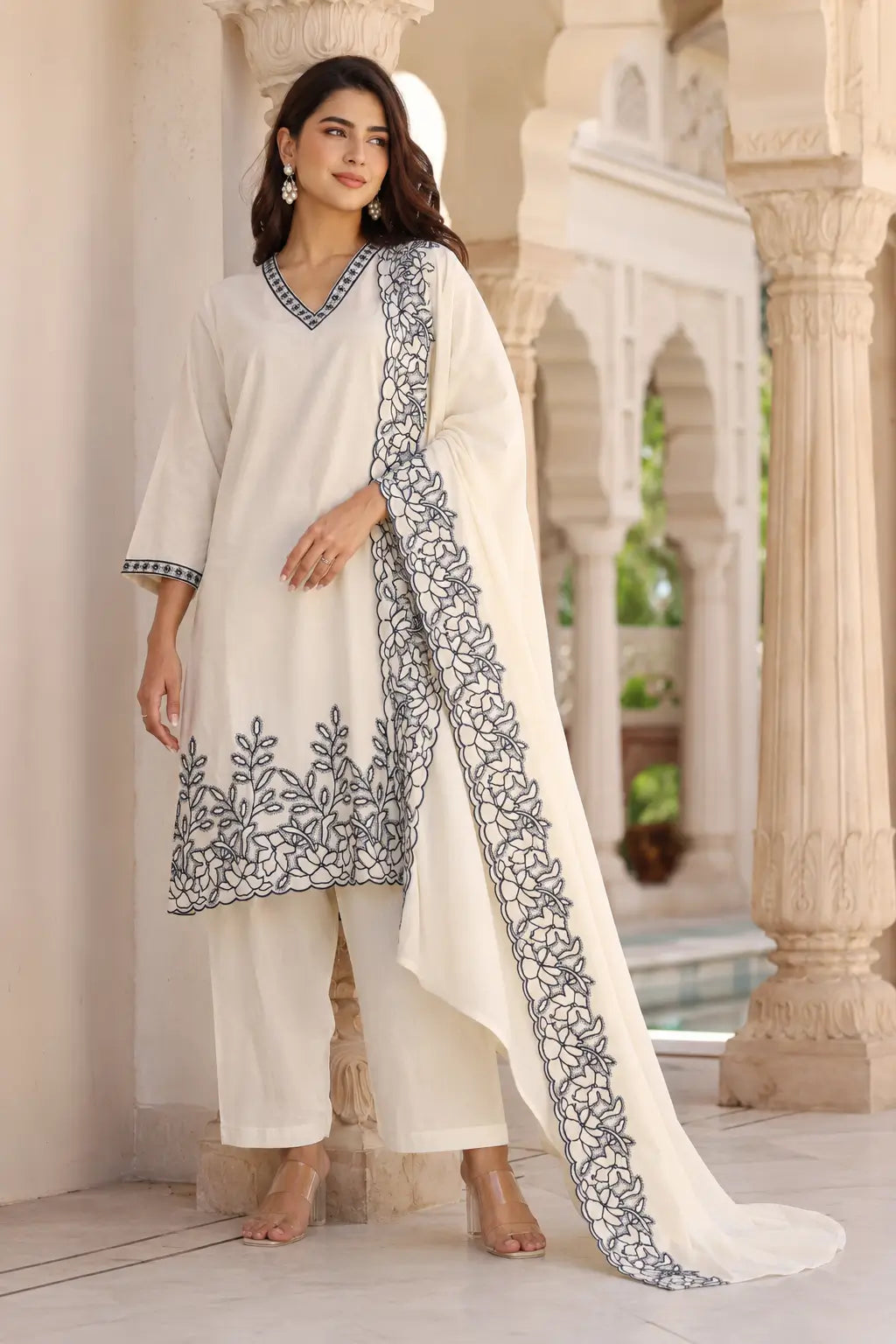 Lifestyle image of Rabric off white cambric cotton ethnic kurta pant set with dupatta styled with casual accessories for women