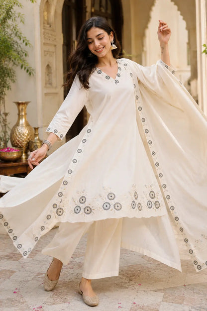 Flowy dancing pose in Rabric off white cambric cotton kurta pant set with lightweight dupatta and floral embroidery
