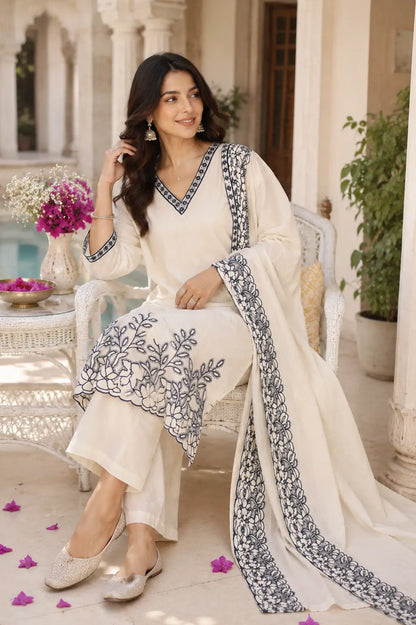 Rabric off white cambric cotton kurta pant set with dupatta in casual sitting pose featuring elegant embroidery and plain pants
