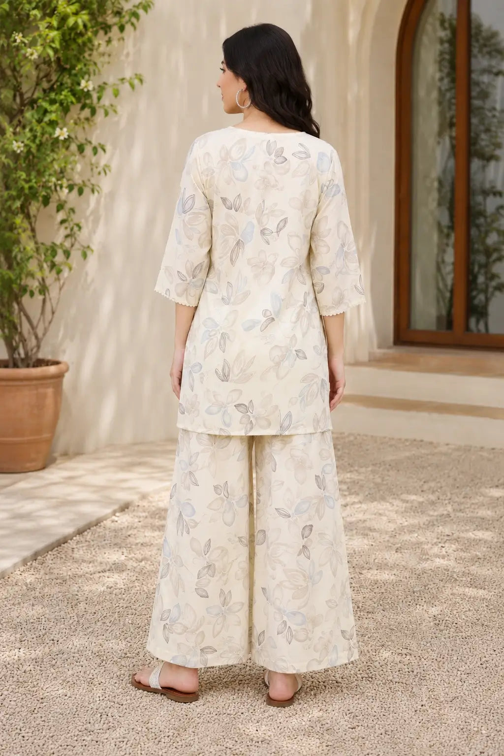 Back view of Rabric off white cotton botanical floral print co-ord set for women with relaxed fit short kurta and matching palazzo pants