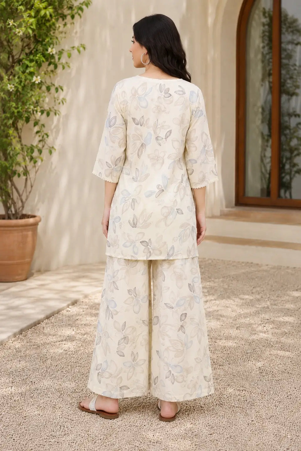 Back view of Rabric off white cotton botanical floral print co-ord set for women with relaxed fit short kurta and matching palazzo pants