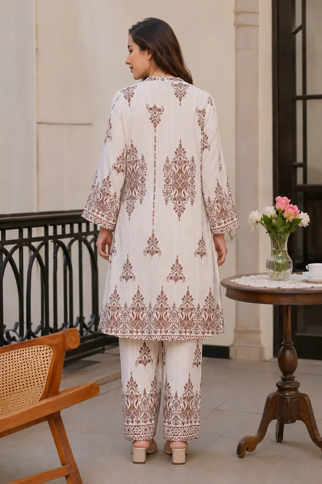Back view of Rabric women cotton co-ord set in off white shade featuring traditional brown floral Mughal print and relaxed fit pants