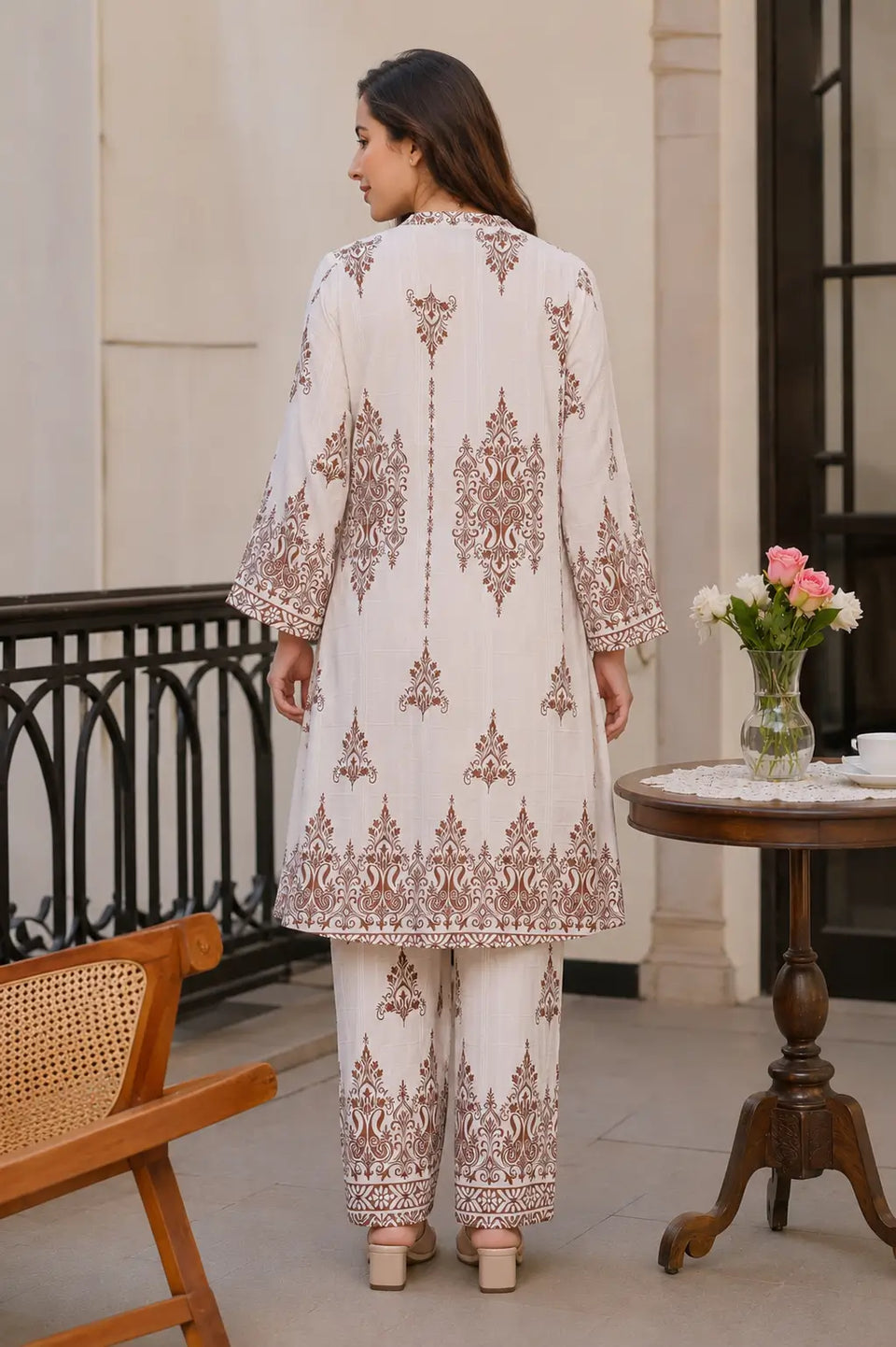 Back view of Rabric women cotton co-ord set in off white shade featuring traditional brown floral Mughal print and relaxed fit pants