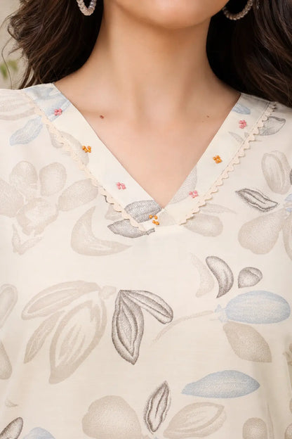 Close up neck design of Rabric off white cotton floral leaf print co-ord set featuring V-neck with delicate bead detailing
