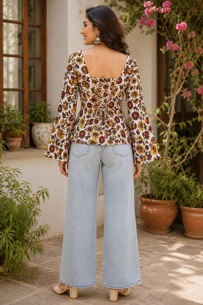 Back view of Rabric off white cotton floral short top featuring square back neck, adjustable dori lace-up design, mustard yellow and maroon floral print