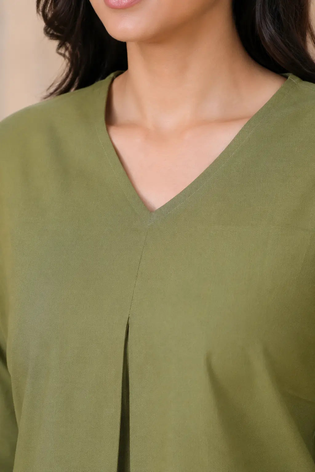Close-up of Rabric olive green cotton co-ord set V-neck design with front pleat and plain solid fabric texture
