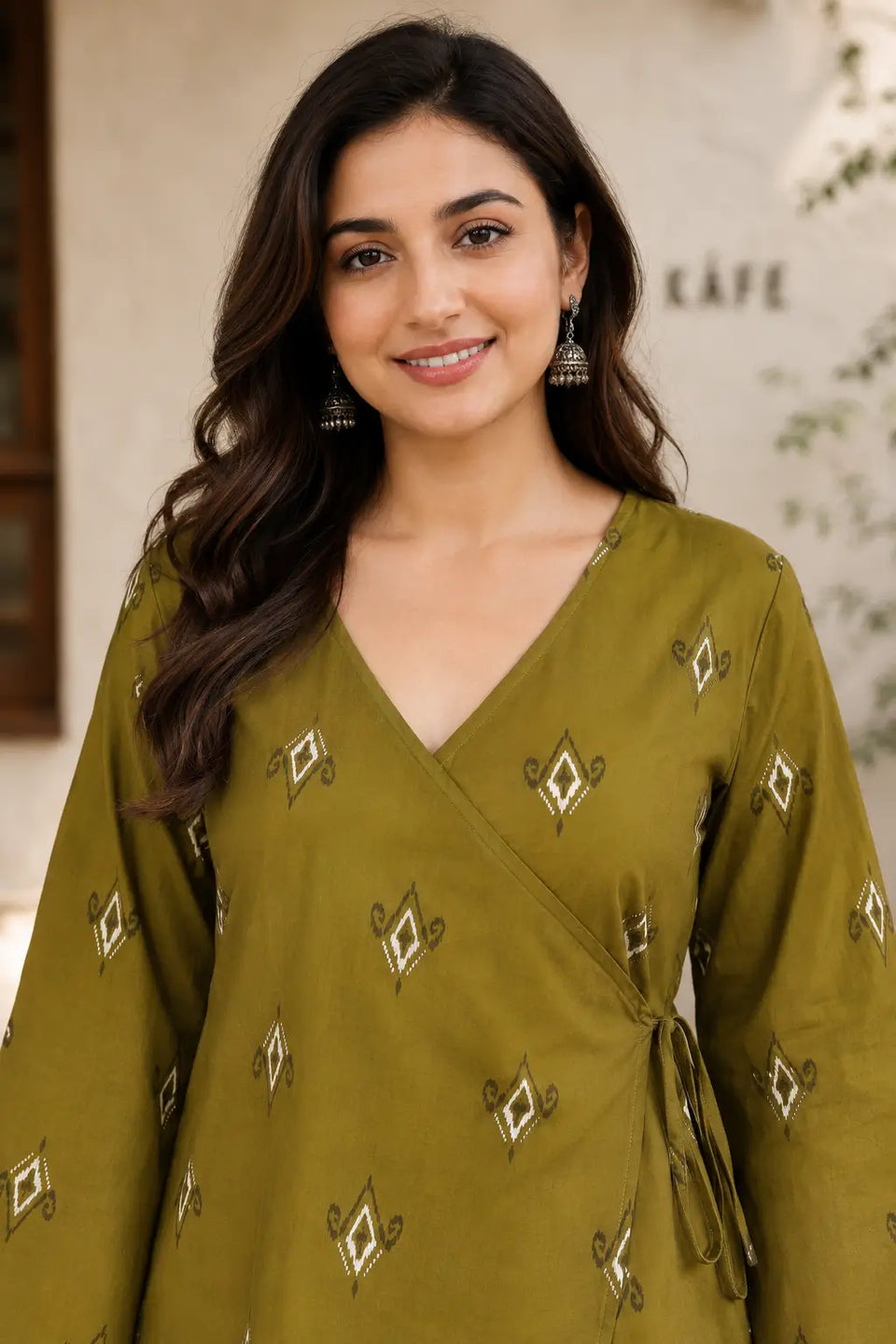Close up of Rabric olive green cotton printed wrap short top with V neck design and ethnic geometric print