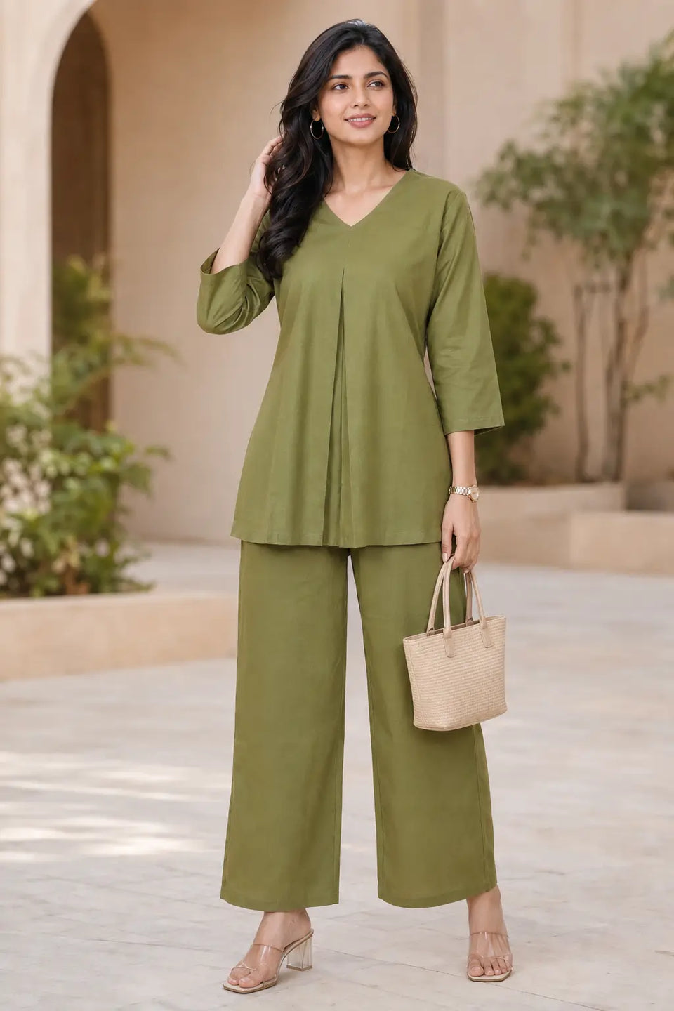 Lifestyle image of Rabric olive green solid cotton co-ord set with casual handbag, V-neck top and wide pajama