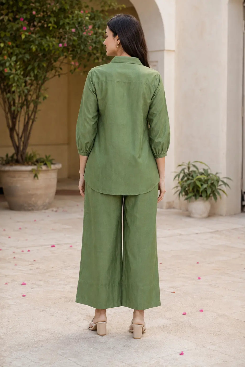 Back view of Rabric olive green Vertican Silk women co-ord set with short kurti, white floral embroidery detailing and wide pajama pants