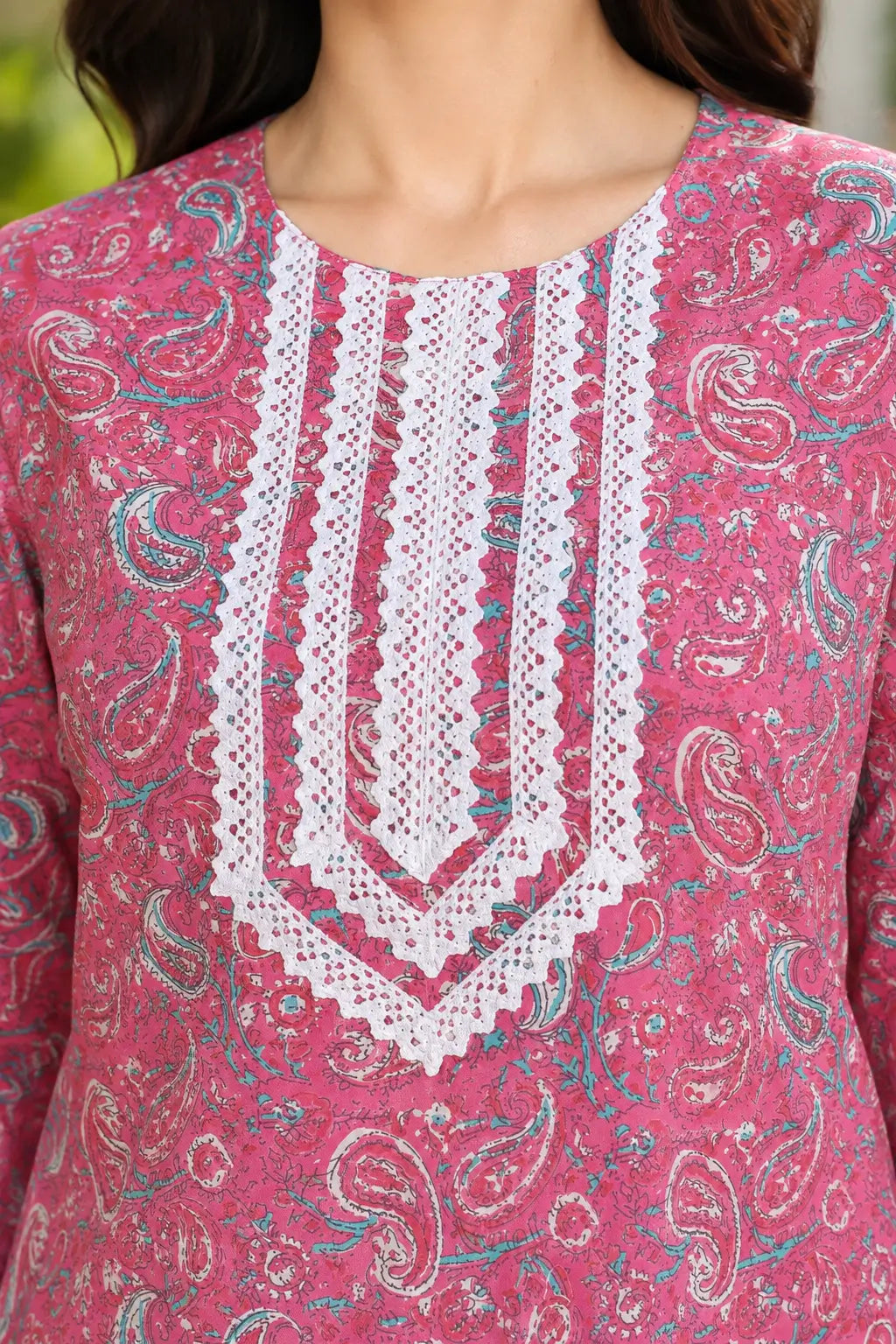Close-up of Rabric pink cotton paisley printed kurti with white embroidered V-neck design and detailed decorative neckline for women