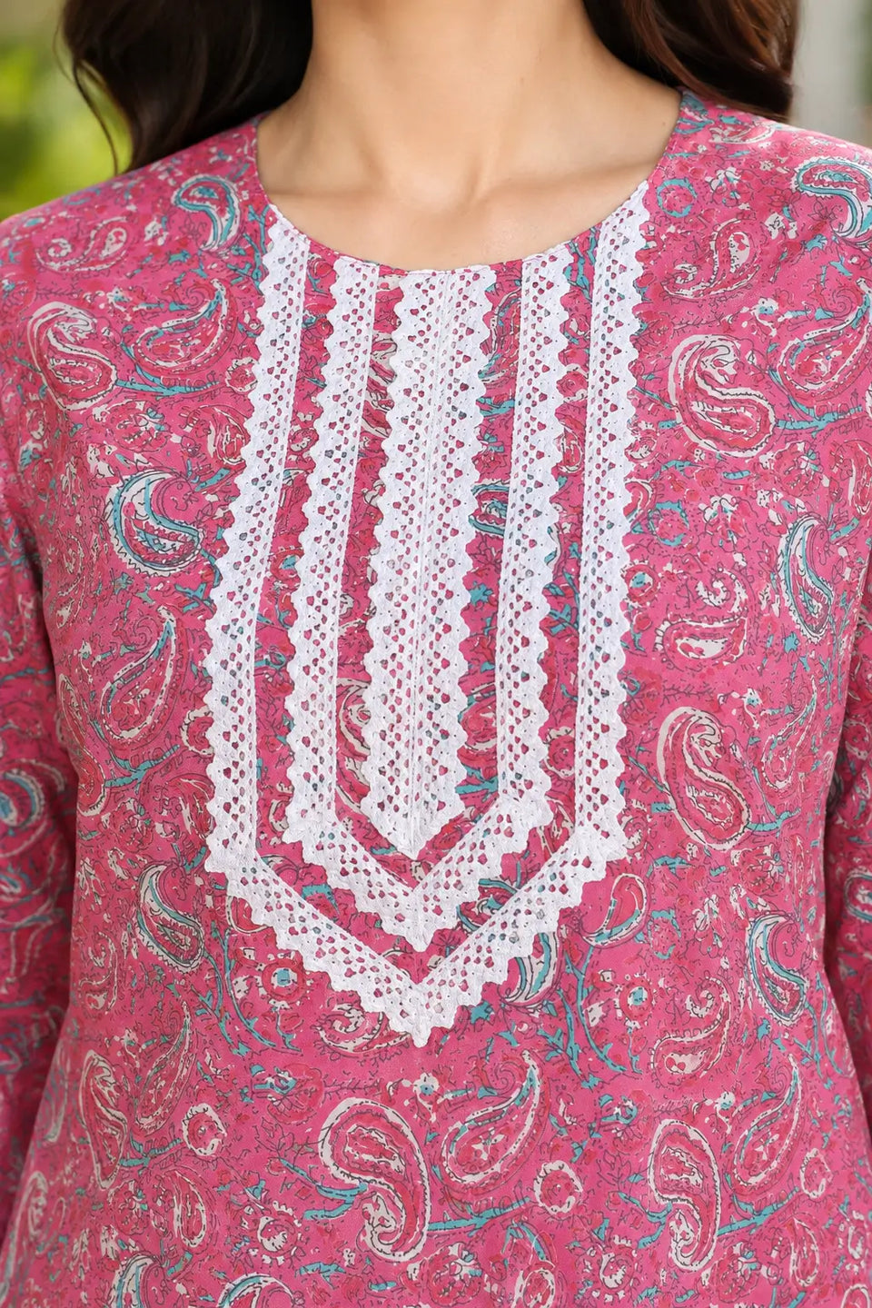 Close-up of Rabric pink cotton paisley printed kurti with white embroidered V-neck design and detailed decorative neckline for women