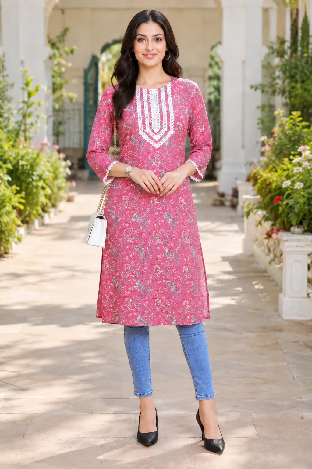 Woman wearing Rabric pink cotton paisley printed straight V-neck embroidered kurti with jeans for a casual outdoor everyday look