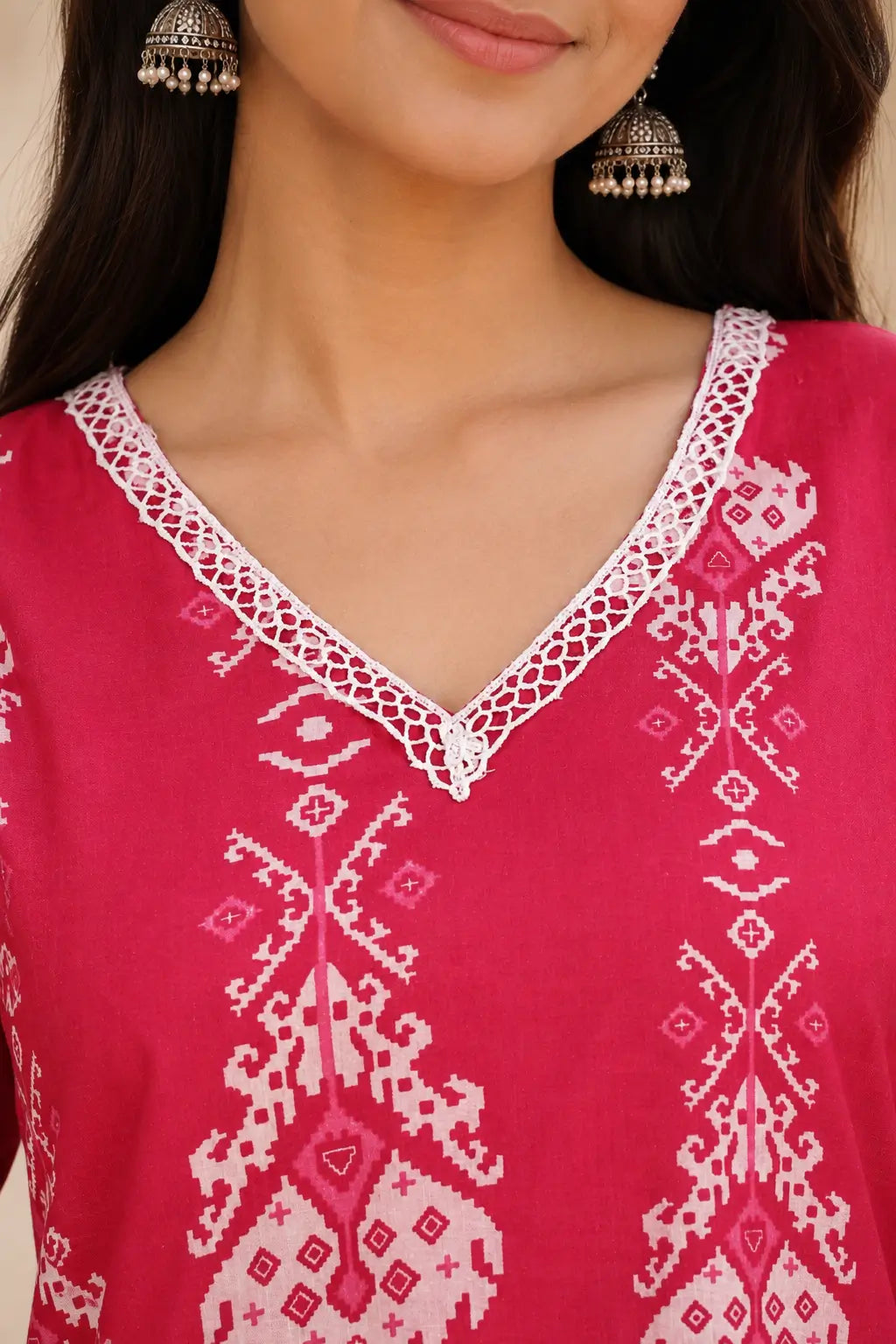 Close-up of Rabric pink cotton ethnic printed kurta featuring V-neck lace detailing, white floral block print and premium cotton fabric