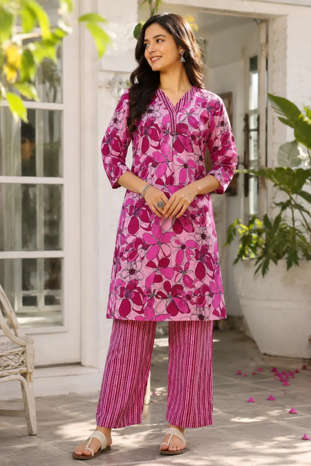 Women pink floral cotton kurta pant set front view by Rabric with 3-4 sleeves and comfortable ethnic wear design