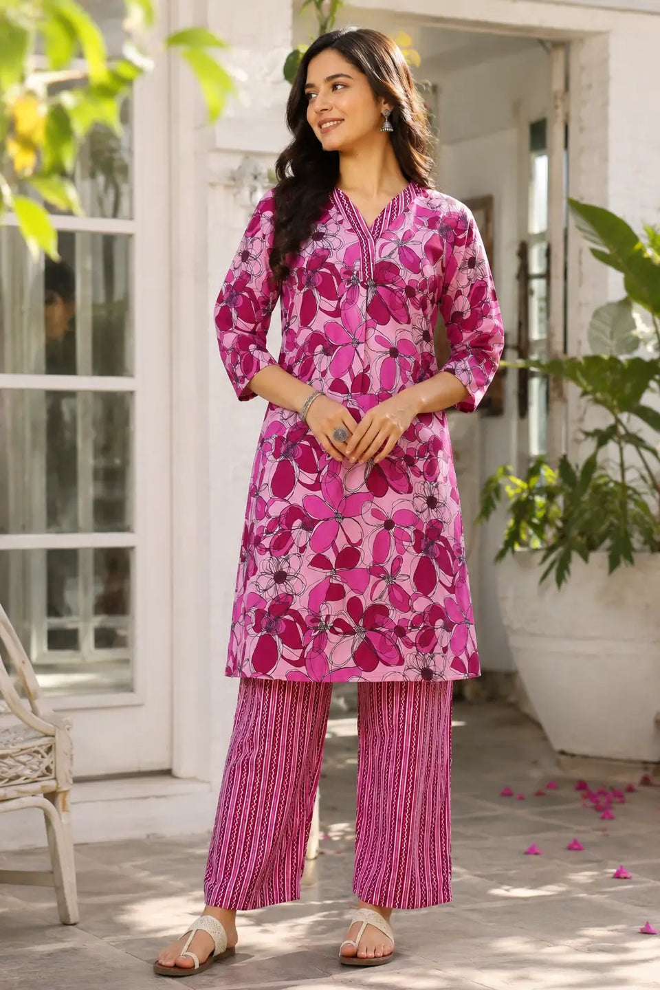 Women pink floral cotton kurta pant set front view by Rabric with 3-4 sleeves and comfortable ethnic wear design