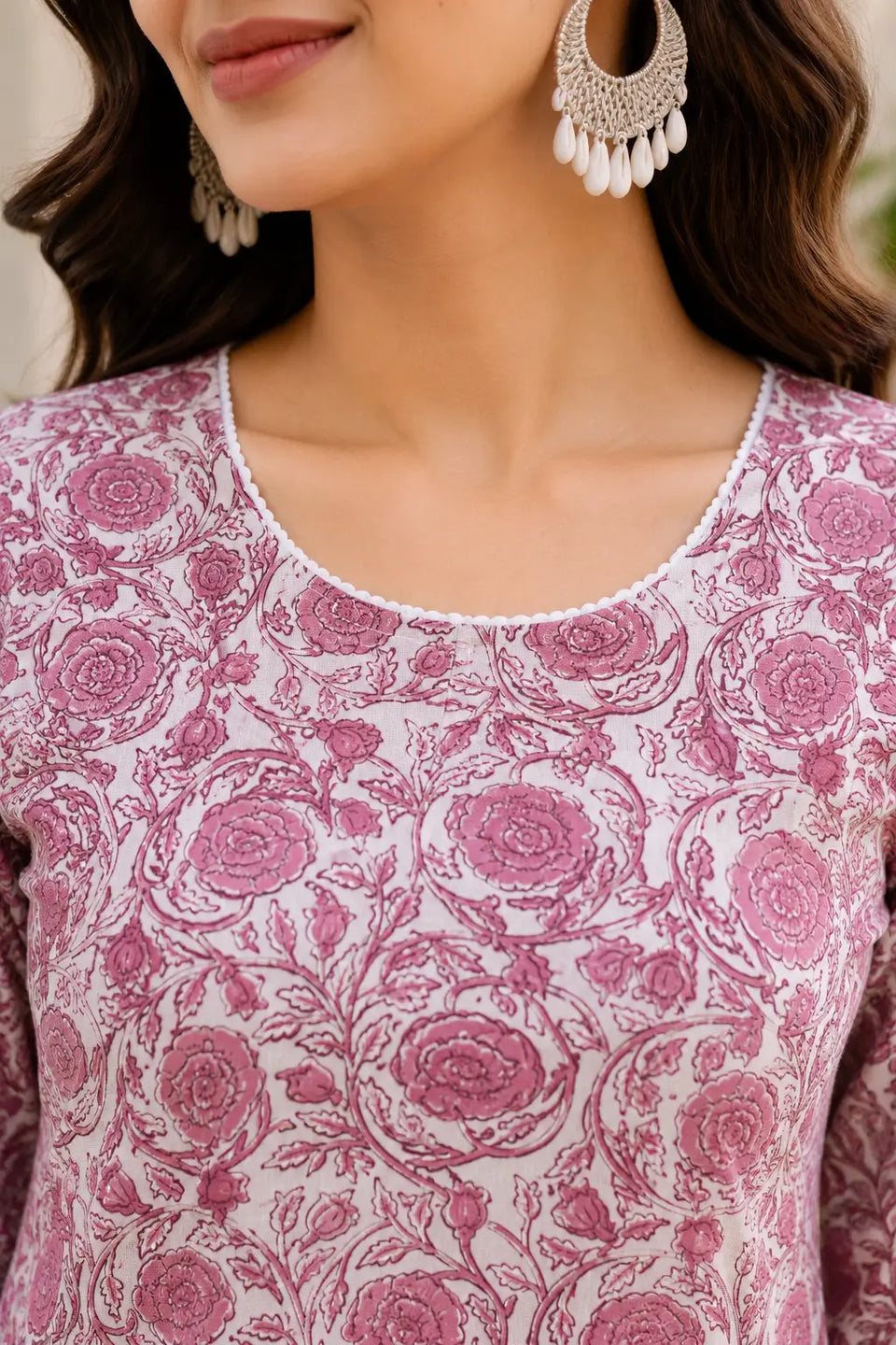 Close up of stylish round neck design on Rabric pink floral cotton kurti for women