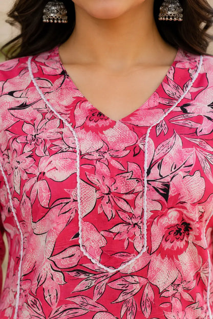 Closeup of stylish V neck design on Rabric pink floral cotton kurti for women with detailed ethnic piping work
