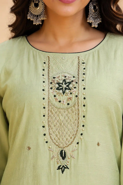 Closeup of embroidered neck design on Rabric pista green cotton kurta pant set with detailed thread and bead work