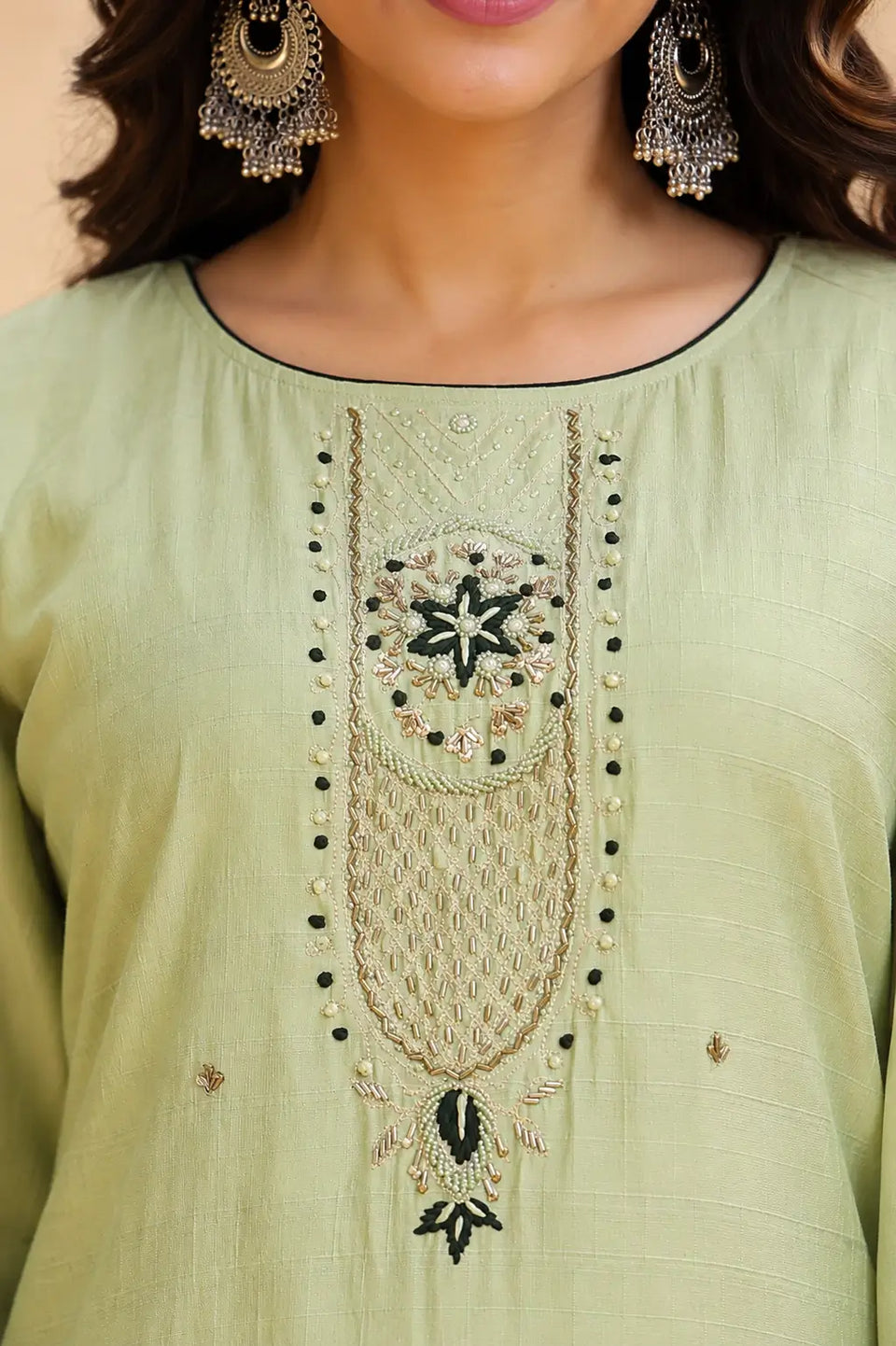 Closeup of embroidered neck design on Rabric pista green cotton kurta pant set with detailed thread and bead work