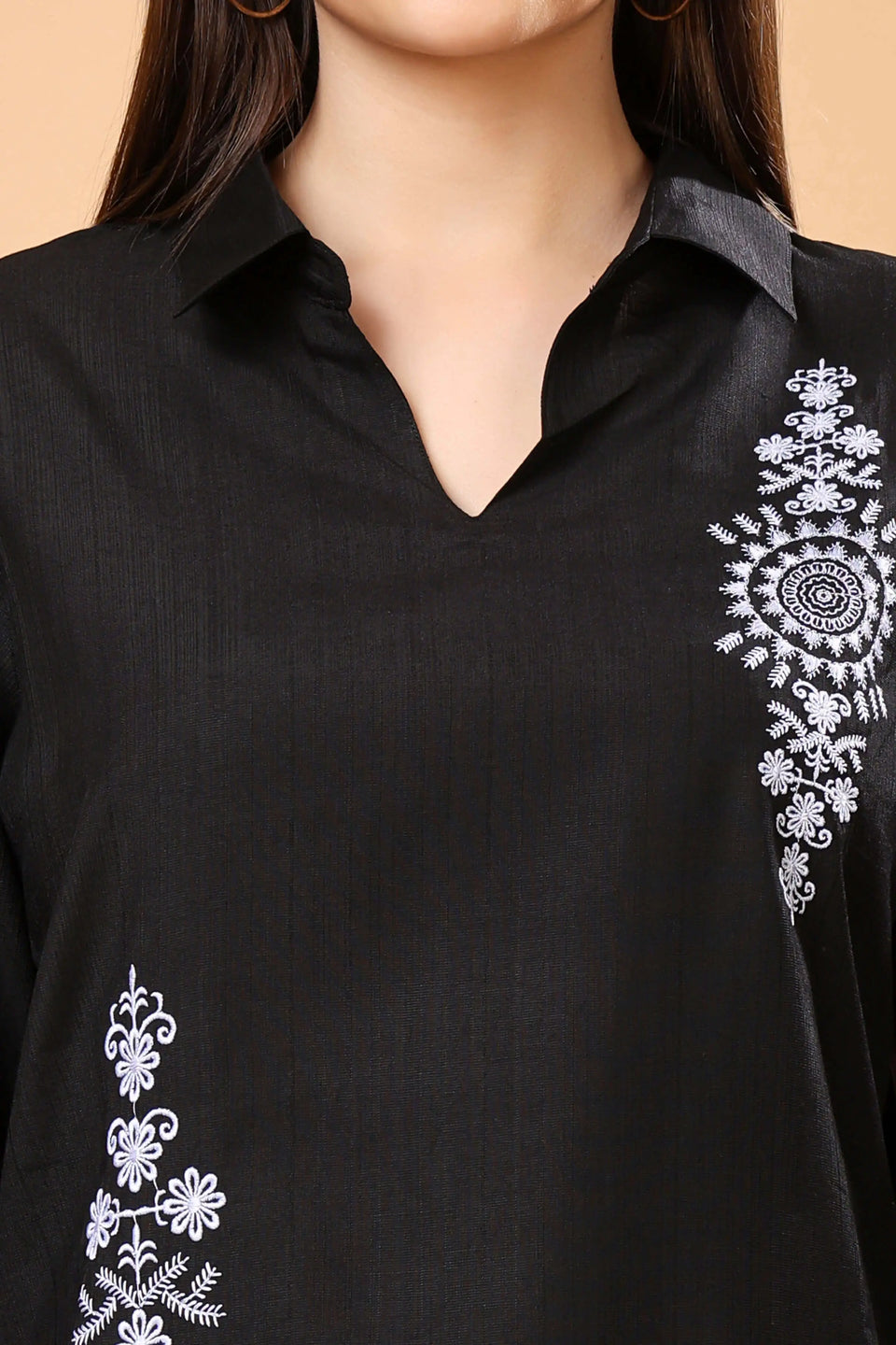 Close-up of embroidery detail on Rabric black co-ord set top