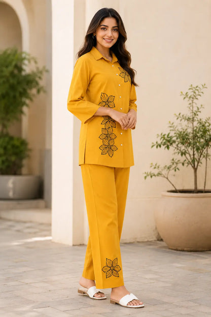 Side angle view of Rabric mustard yellow rayon floral co-ord set for women with relaxed fit shirt, 3/4 sleeves and straight pants