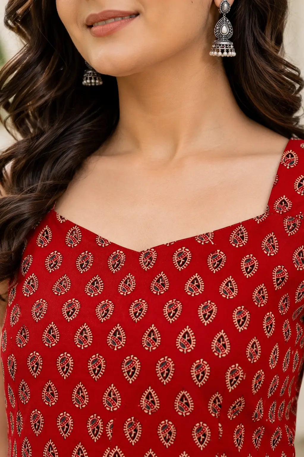 Closeup of sweetheart neckline on Rabric red cotton sleeveless short top with elegant ethnic paisley print for women.
