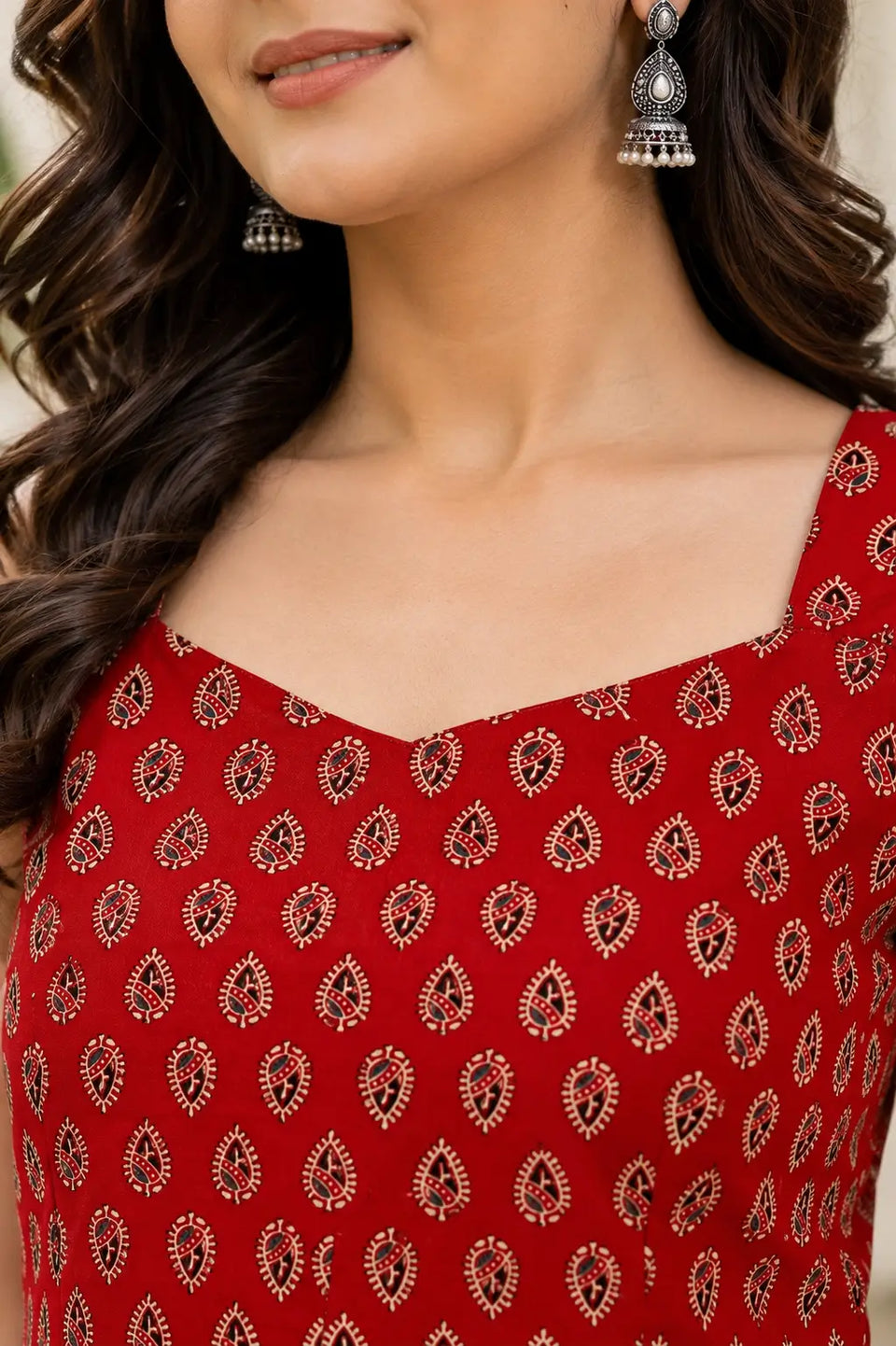 Closeup of sweetheart neckline on Rabric red cotton sleeveless short top with elegant ethnic paisley print for women.
