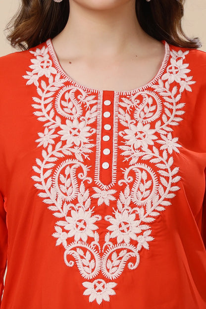 Closeup of white floral embroidery on red Crepe short kurti