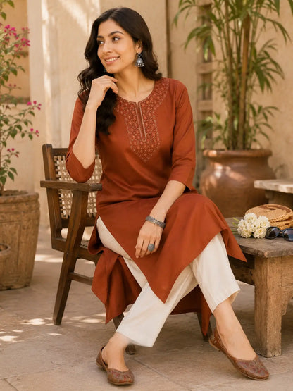 Rabric rust brown Tencel women kurti in relaxed sitting pose with casual accessories and elegant ethnic fashion styling