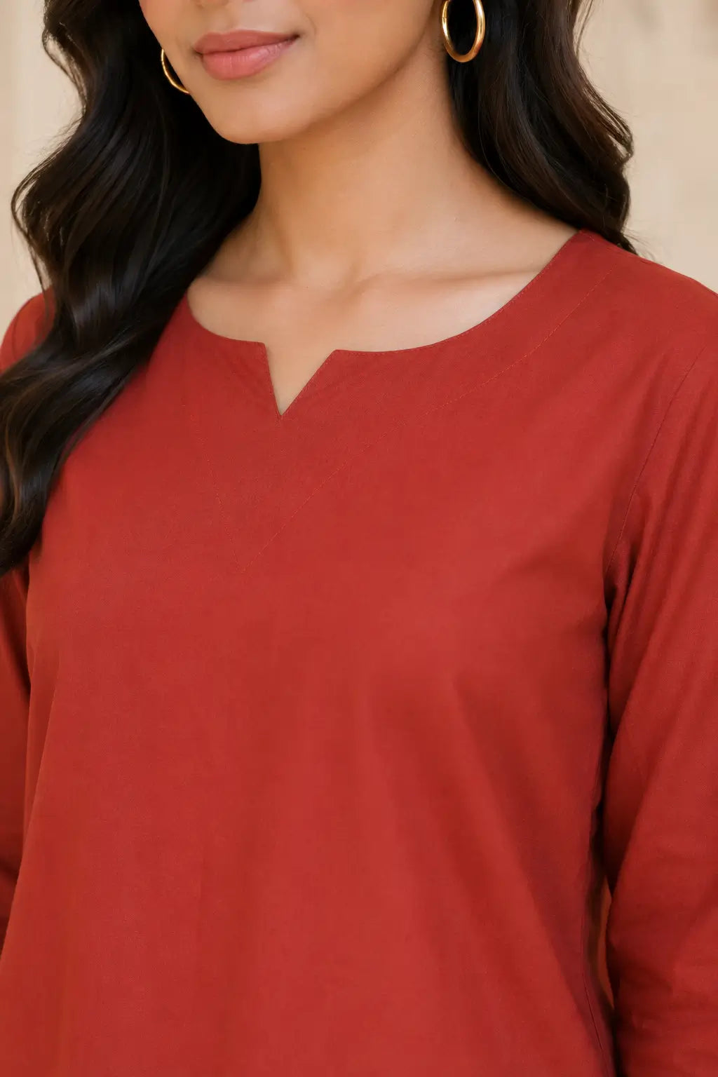 Rabric rust red cotton co-ord set close up showing notch neck design and plain solid fabric texture