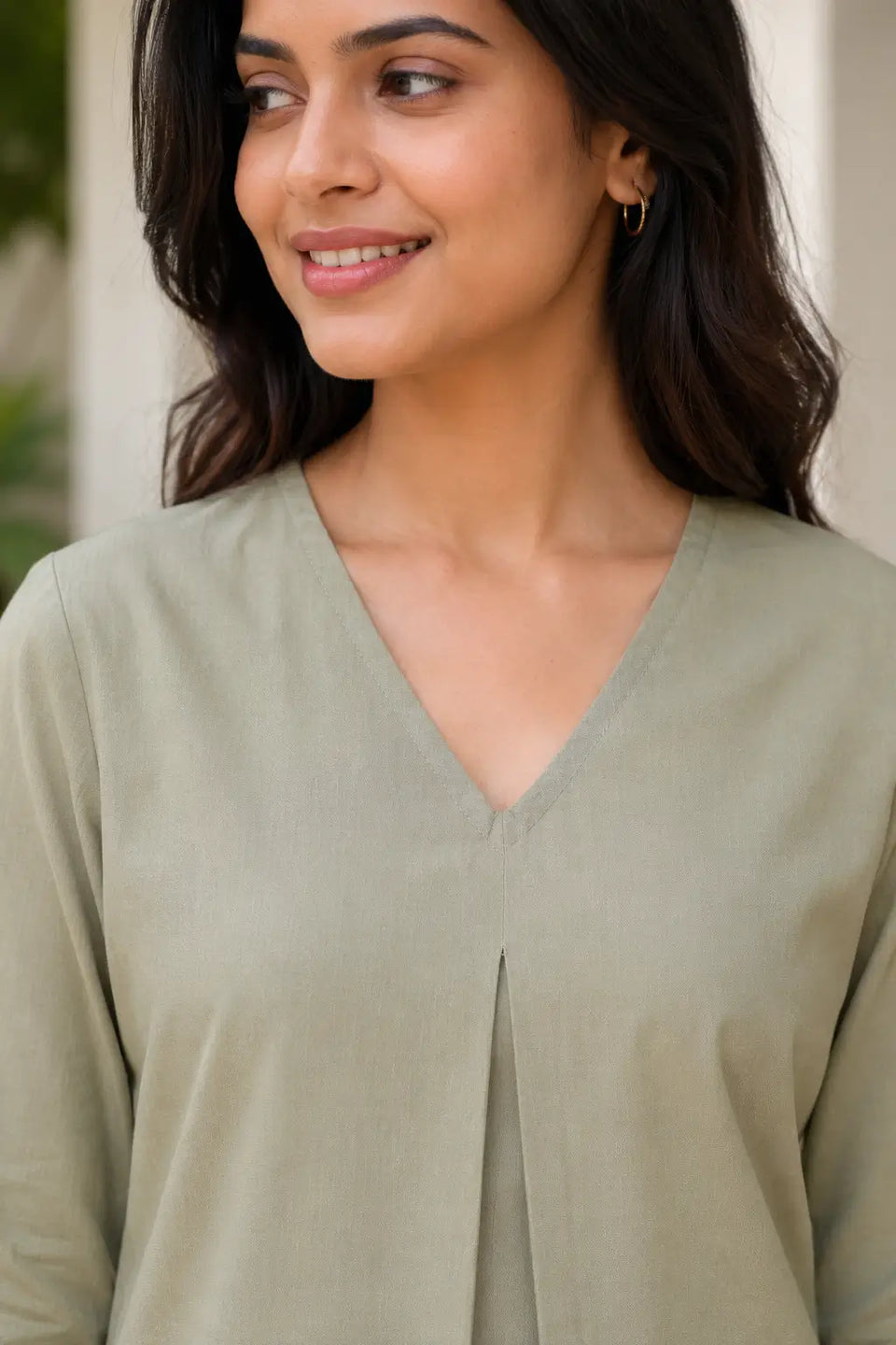 Close up of Rabric sage green cotton co-ord set showing V-neck design and front pleat detail on kurti