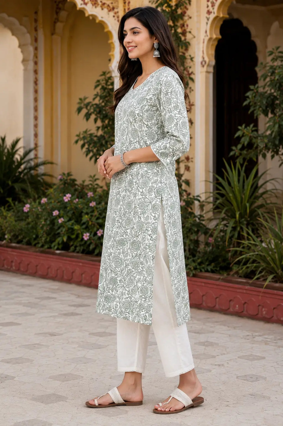 Side angle view of Rabric women cotton floral print kurti in sage green color with stylish side slit