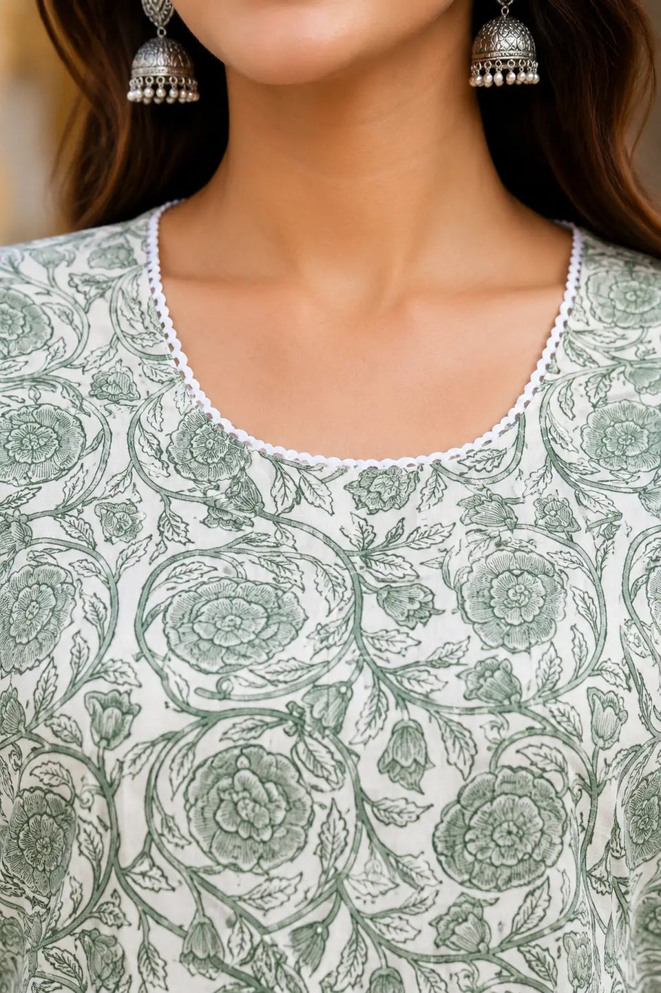 Closeup of round neck design on Rabric sage green floral cotton women kurti with detailed piping