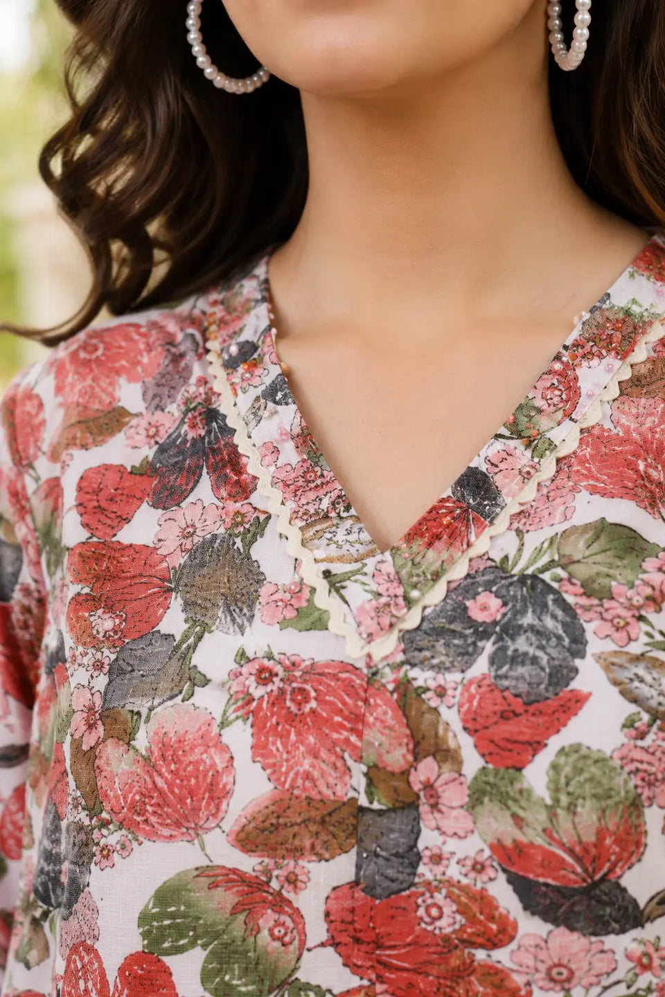 Close-up V-neck design of Rabric women's soft pink cotton floral printed co-ord set with decorative lace detailing and multicolor botanical flower print